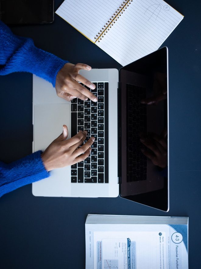 A desk with a laptop and paperwork