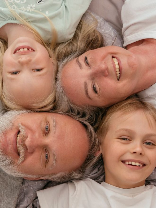Family lying together, smiling